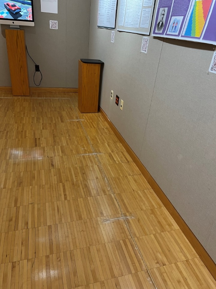 An image of the Art of Measurement and Measure of Art exhibition that illustrates the floor tracking we used to guide people through the exhibition.  The floor tracking consists of twine rope taped to the ground.